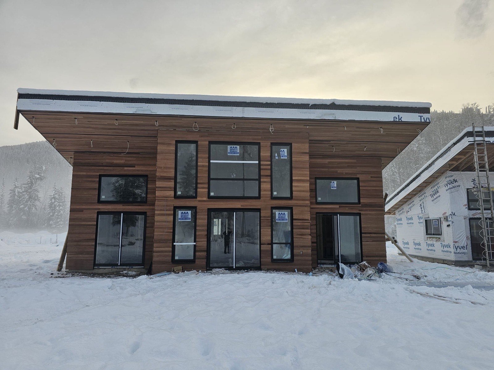 Finished two-storey cabin with clear cedar cladding in winter